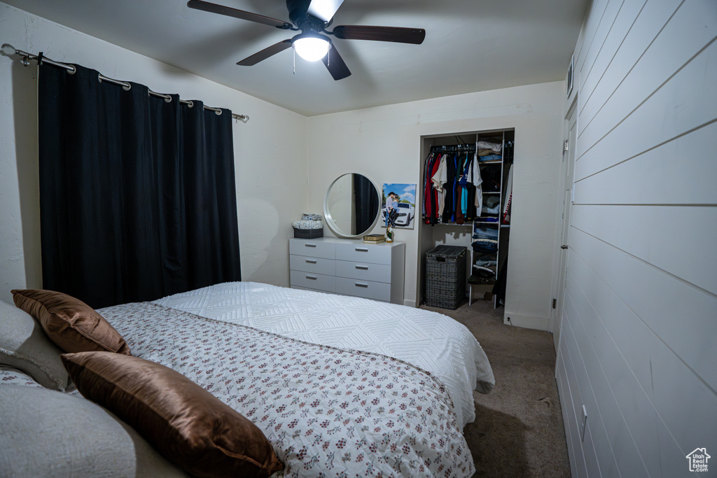 Bedroom with carpet, a closet, and a ceiling fan