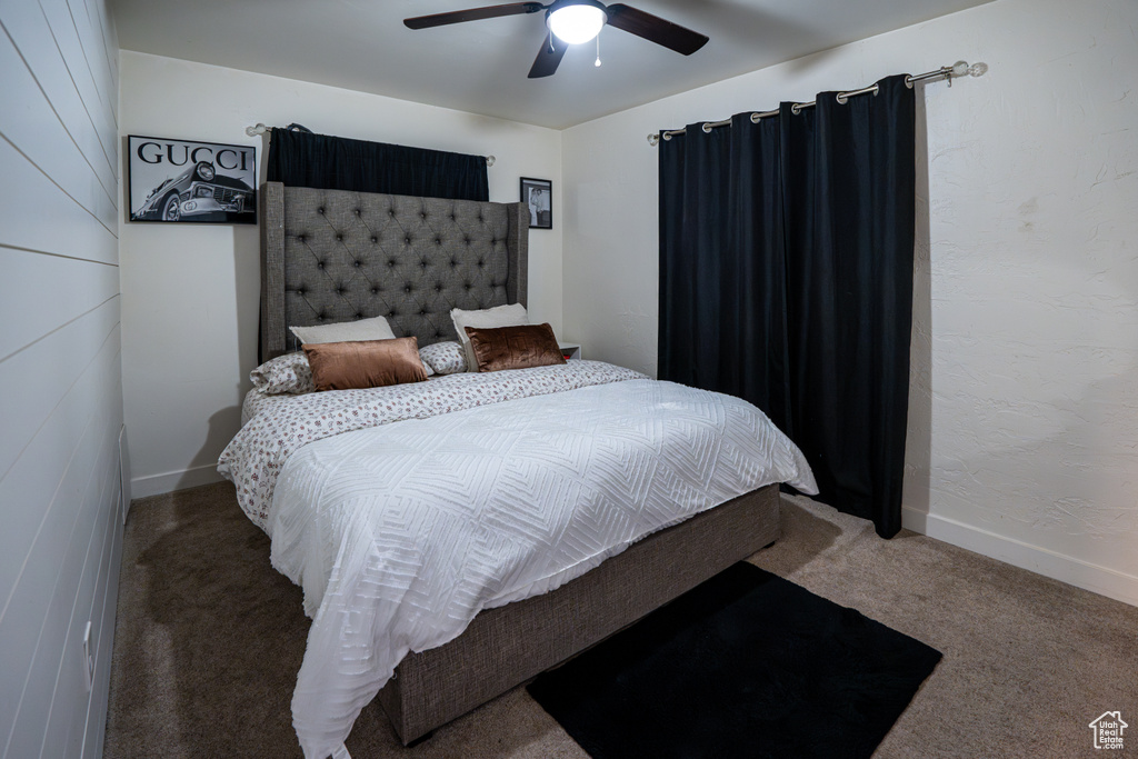 Bedroom featuring carpet, a ceiling fan, and baseboards