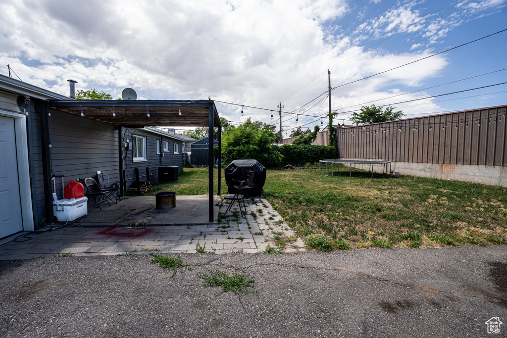View of yard with a patio and cooling unit