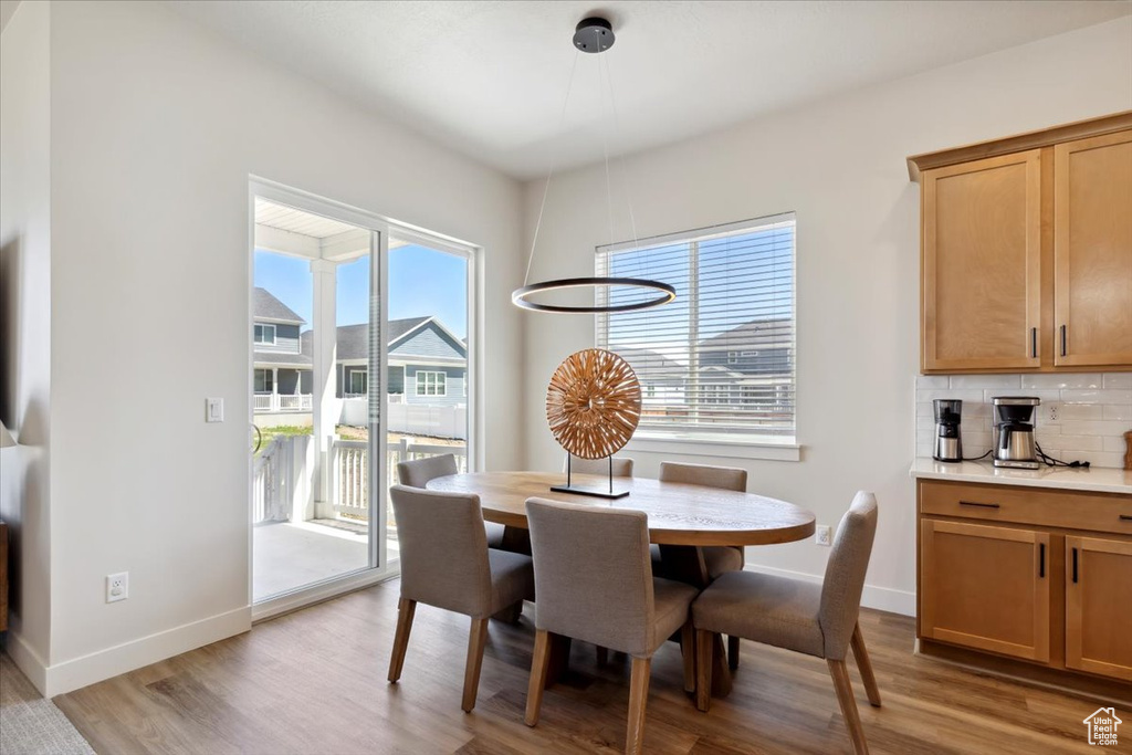 Dining area featuring light wood-style floors and baseboards