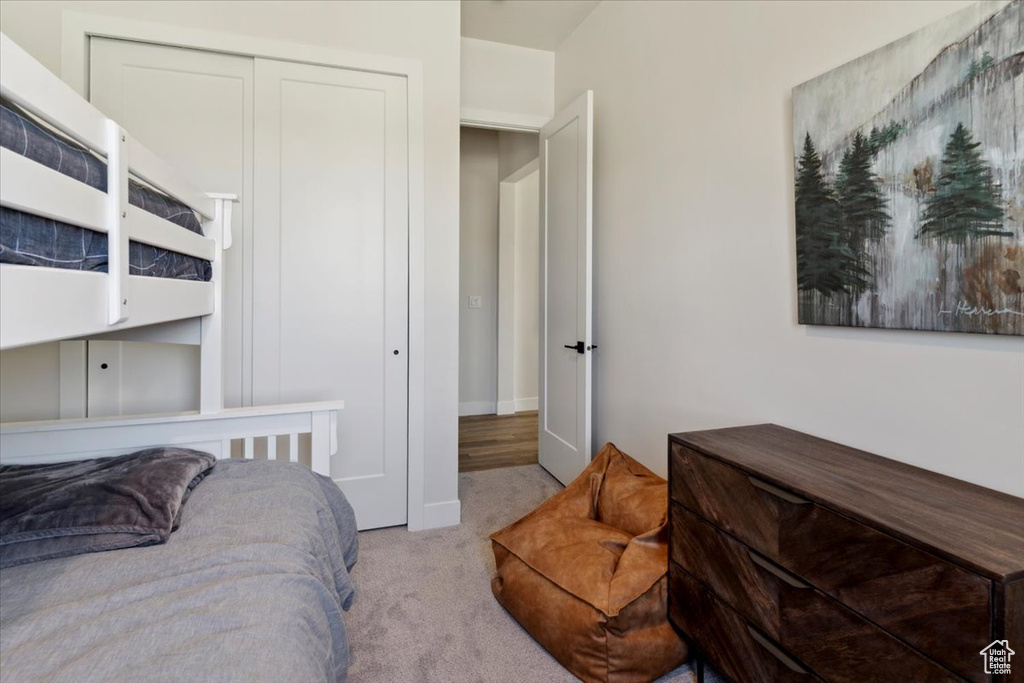 Bedroom featuring carpet floors, baseboards, and a closet
