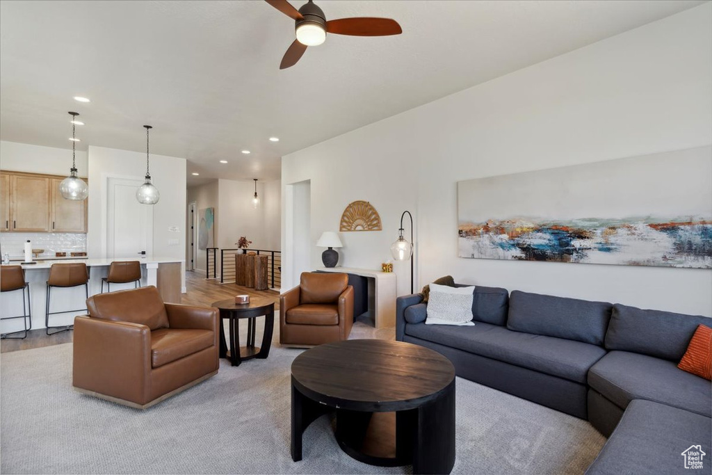 Living room featuring a ceiling fan and recessed lighting