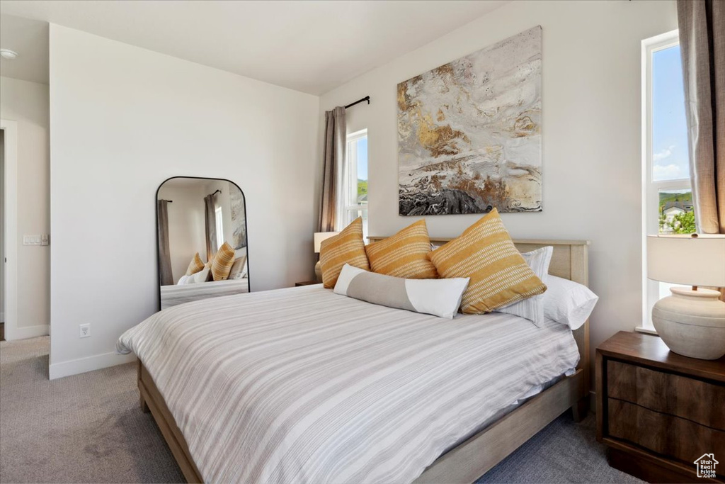 Bedroom featuring carpet flooring and baseboards