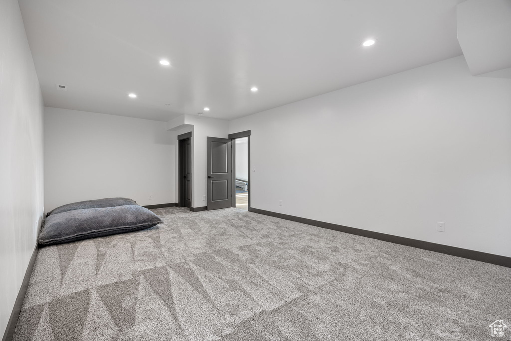 Unfurnished bedroom with carpet, recessed lighting, and baseboards