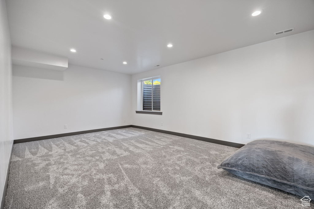 Carpeted spare room featuring recessed lighting and baseboards