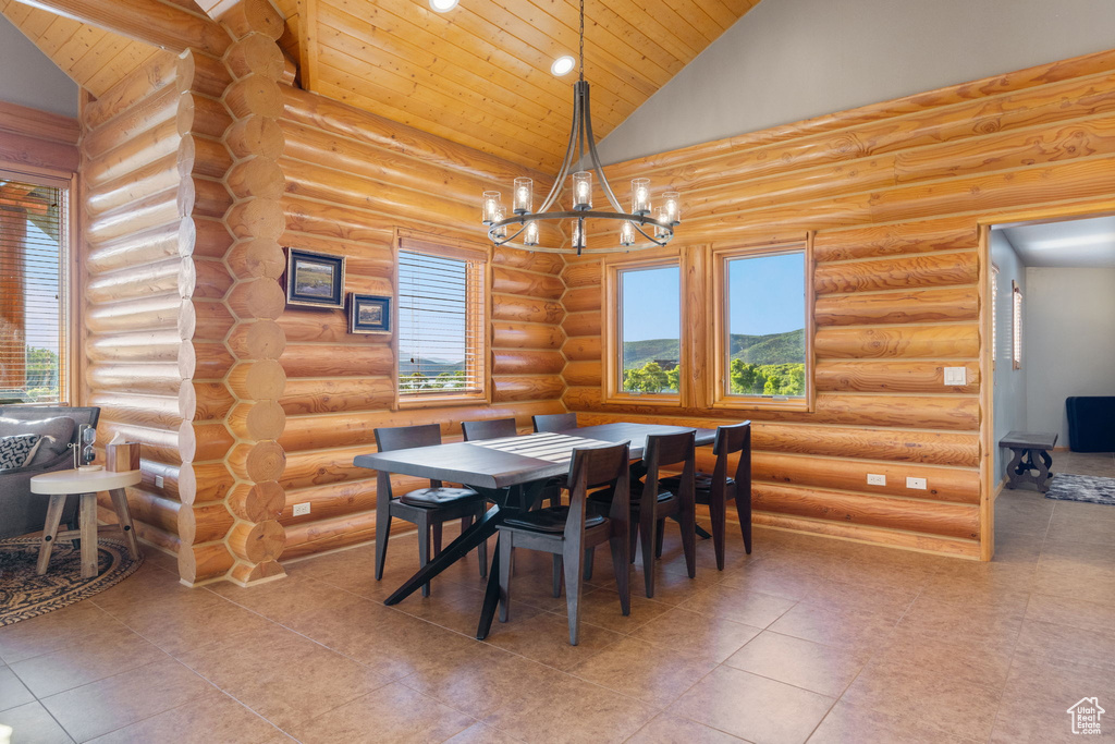 Tiled dining area featuring log walls, wooden ceiling, a chandelier, high vaulted ceiling, and recessed lighting