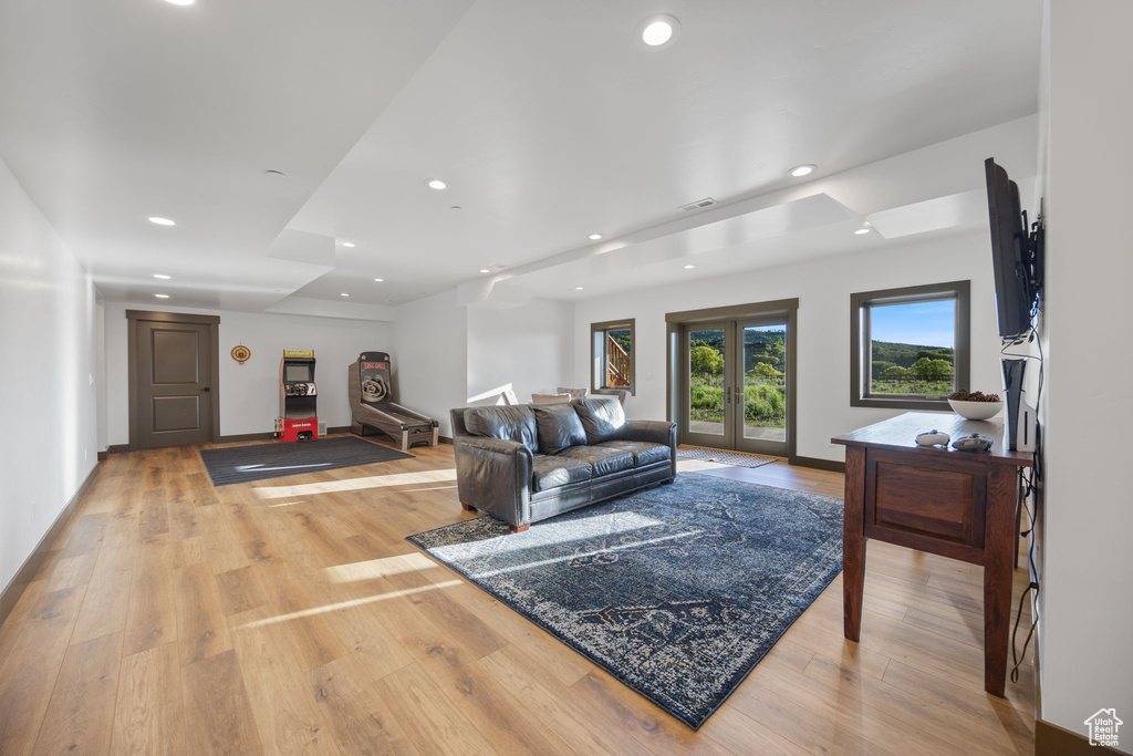 Living room with recessed lighting, light wood-type flooring, and baseboards