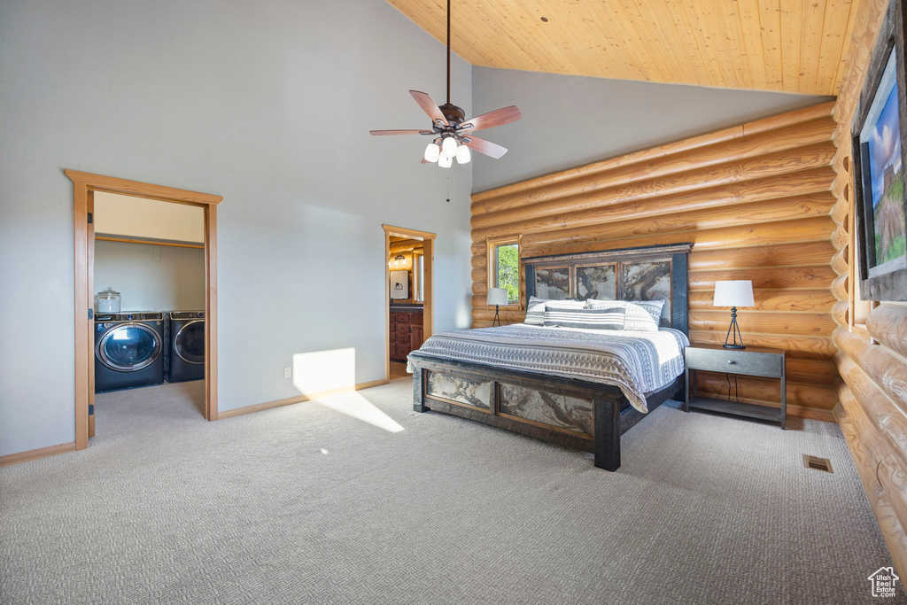 Carpeted bedroom featuring washing machine and dryer, rustic walls, high vaulted ceiling, wood ceiling, and baseboards