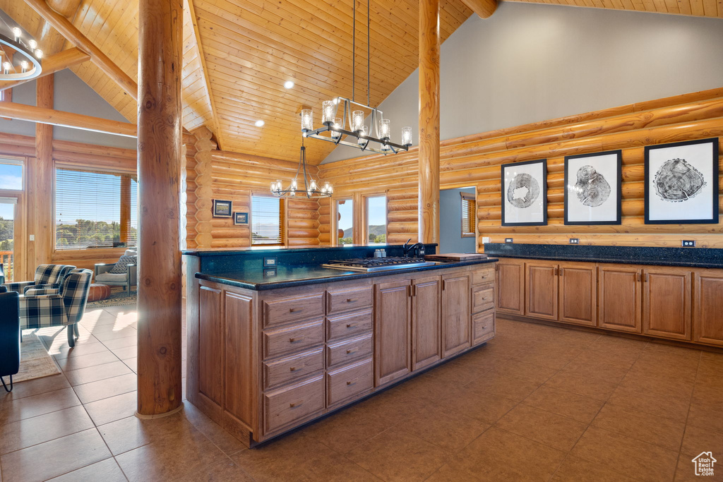 Kitchen with log walls, high vaulted ceiling, wood ceiling with exposed beams, a chandelier, and dark countertops