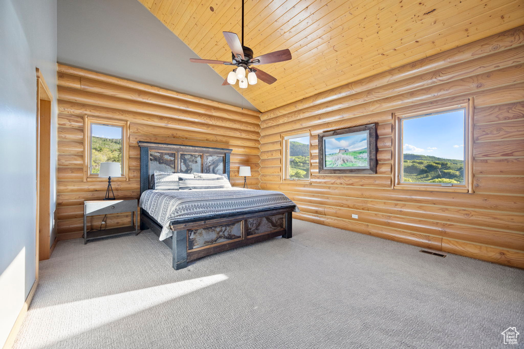 Bedroom with high vaulted ceiling, carpet, rustic walls, ceiling fan, and wood ceiling