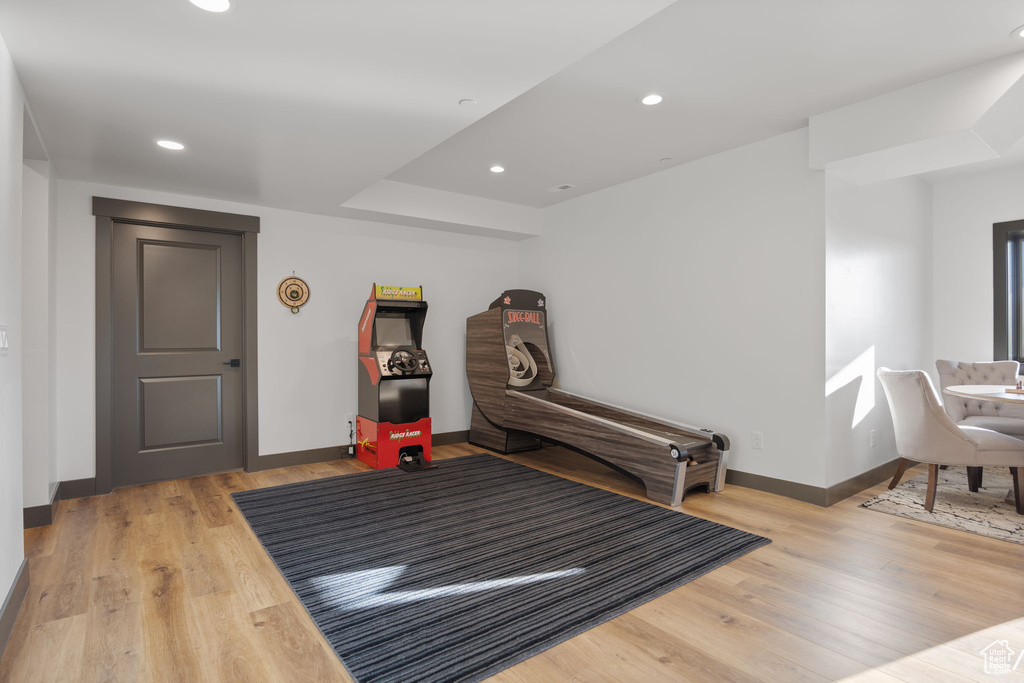 Workout room with baseboards, wood finished floors, and recessed lighting