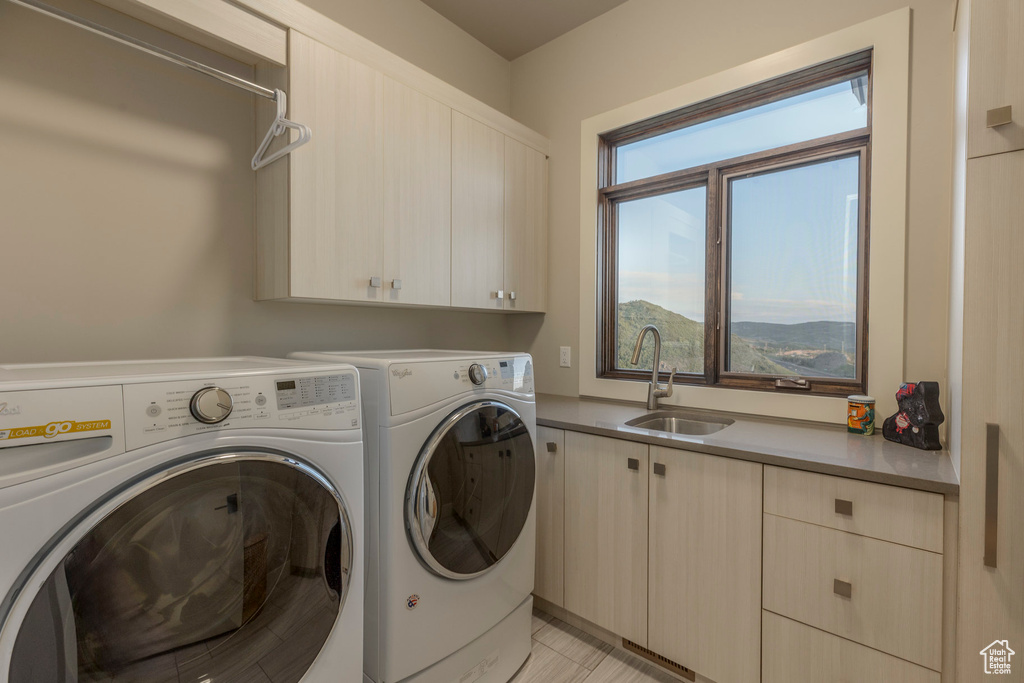 Laundry room with cabinet space and washer and clothes dryer