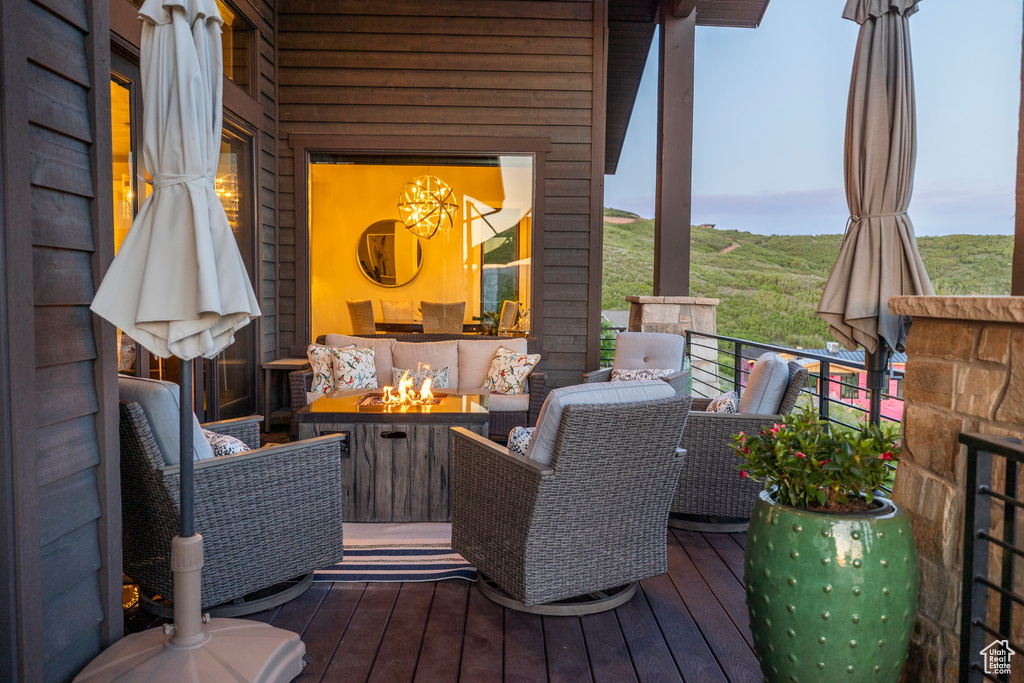 Wooden terrace with an outdoor living space with a fire pit