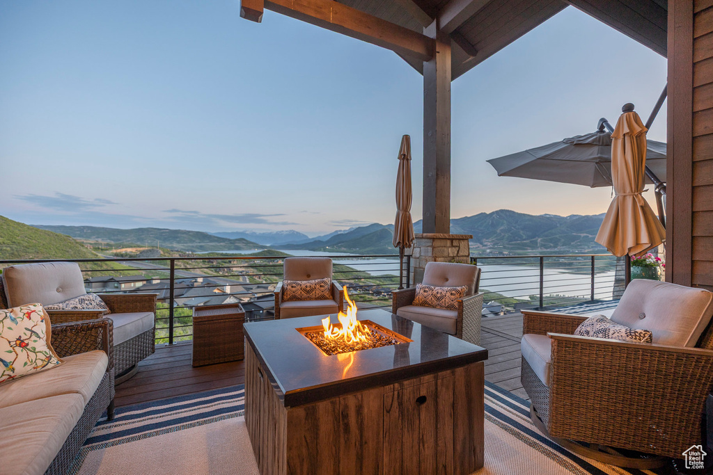 View of patio / terrace with a mountain view and an outdoor living space with a fire pit