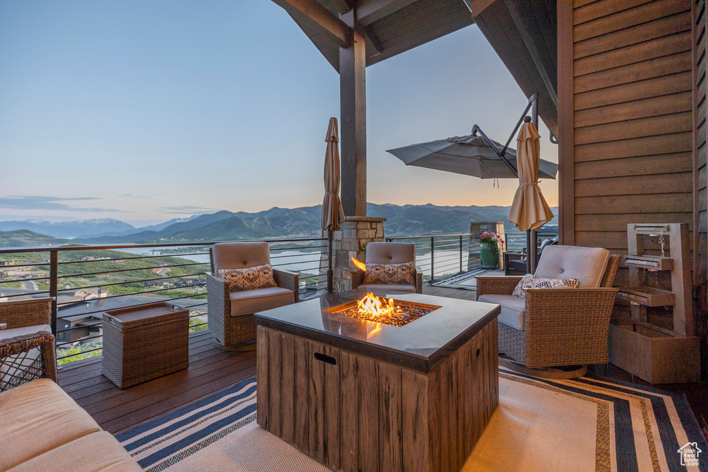 View of patio featuring a mountain view and an outdoor fire pit