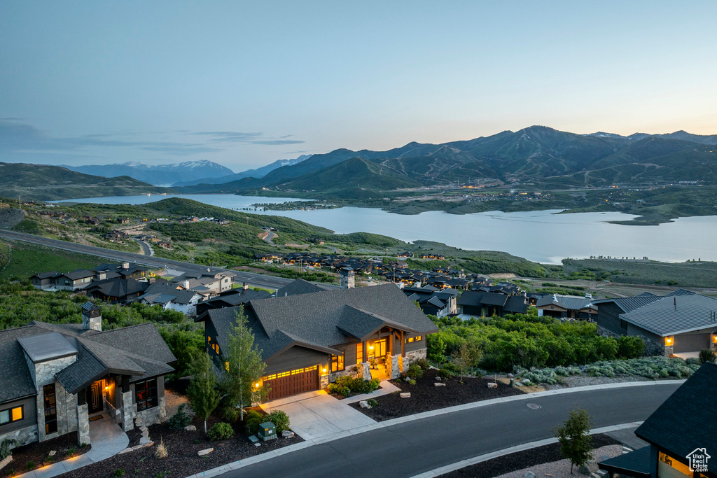View of mountain backdrop featuring a nearby body of water and nearby suburban area