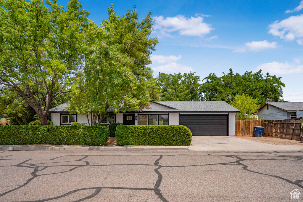 View of front facade with a garage and concrete driveway