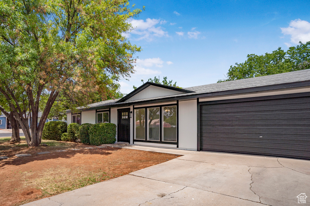 Single story home featuring an attached garage and driveway