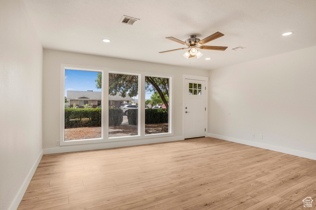 Spare room with a ceiling fan, baseboards, light wood-style floors, and recessed lighting