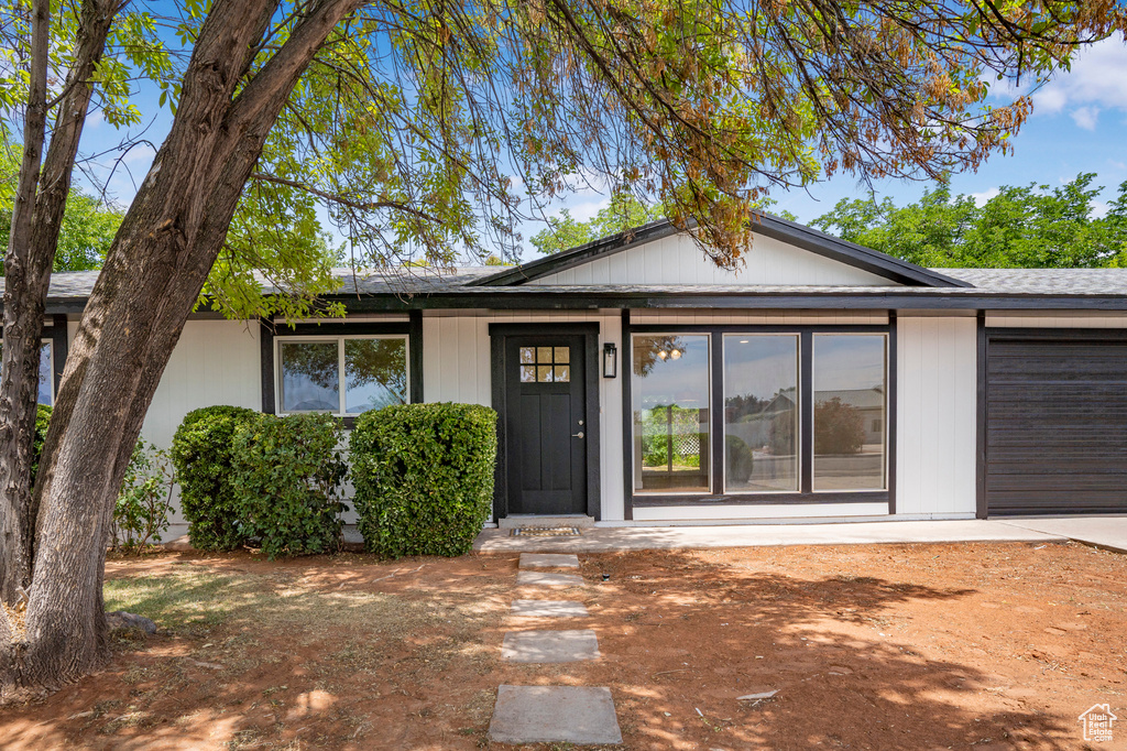 View of front of property featuring an attached garage and concrete driveway
