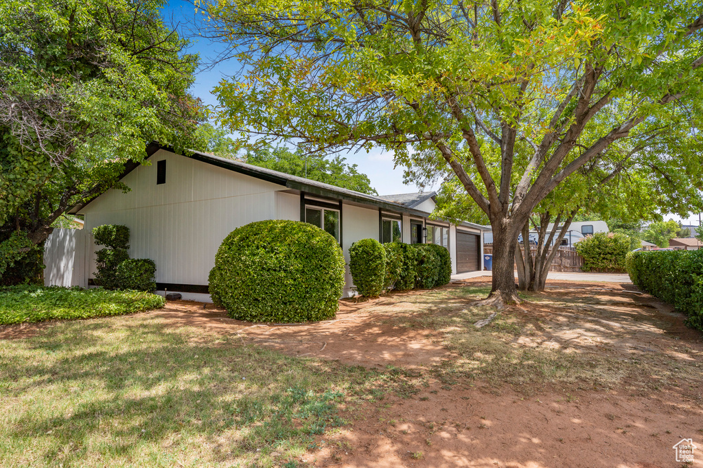 View of front of home with a garage and driveway
