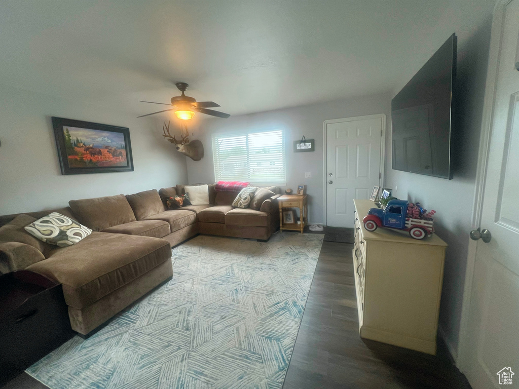 Living area featuring a ceiling fan and wood finished floors