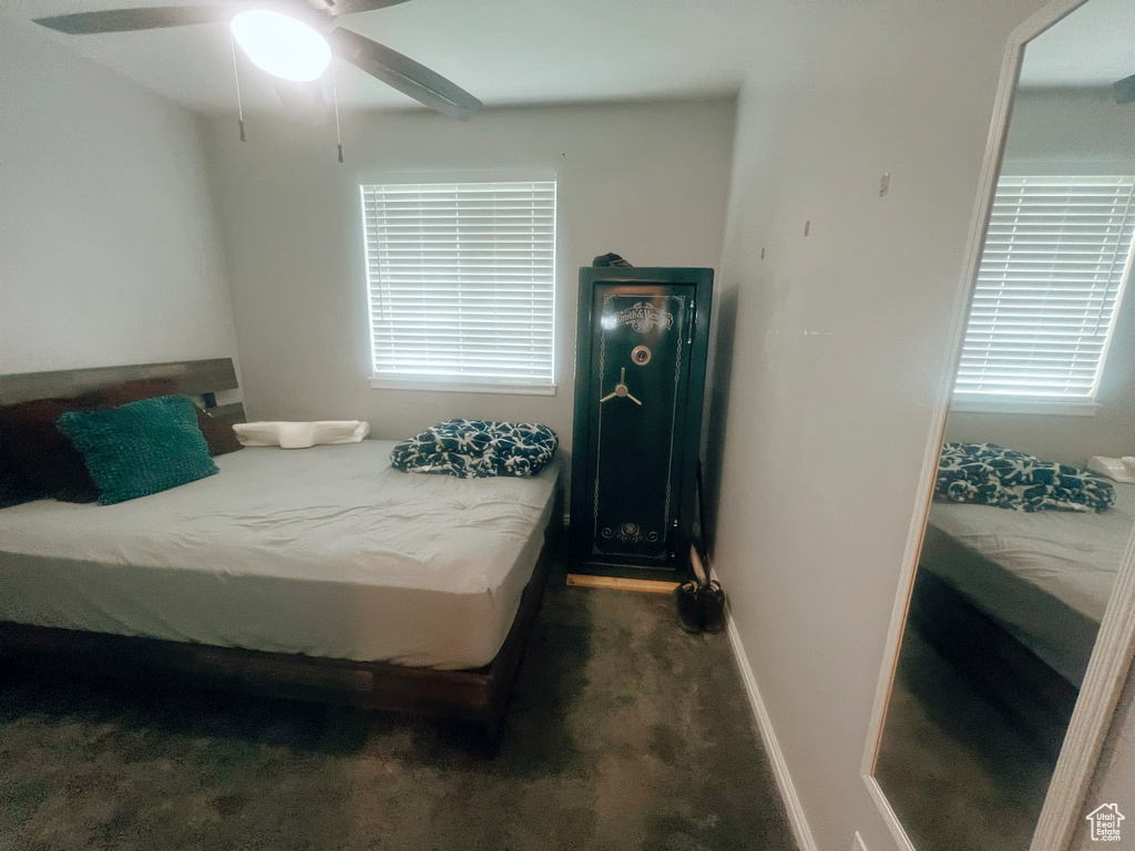 Bedroom with carpet floors, baseboards, and ceiling fan