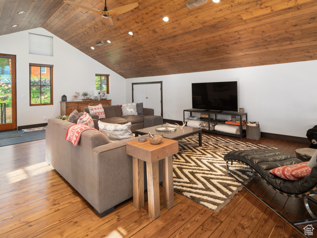 Living area with hardwood / wood-style floors, wood ceiling, vaulted ceiling, baseboards, and recessed lighting