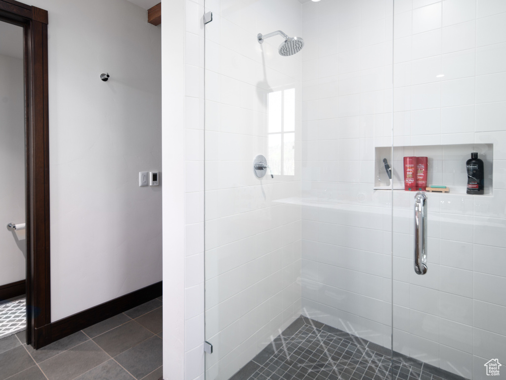 Full bathroom with a stall shower and tile patterned floors