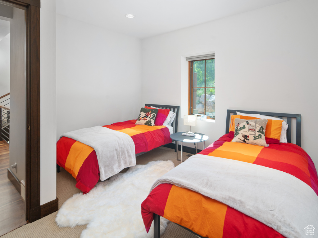 Carpeted bedroom with recessed lighting and baseboards