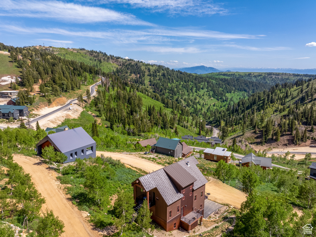 View from above of property with a forest and mountains