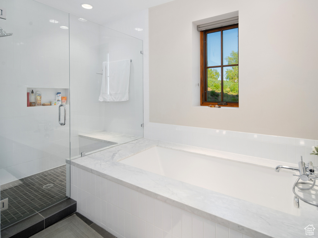Full bathroom with a stall shower and a bath