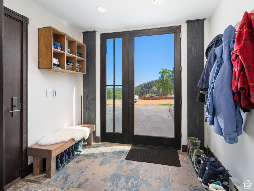Mudroom featuring recessed lighting and stone finish flooring