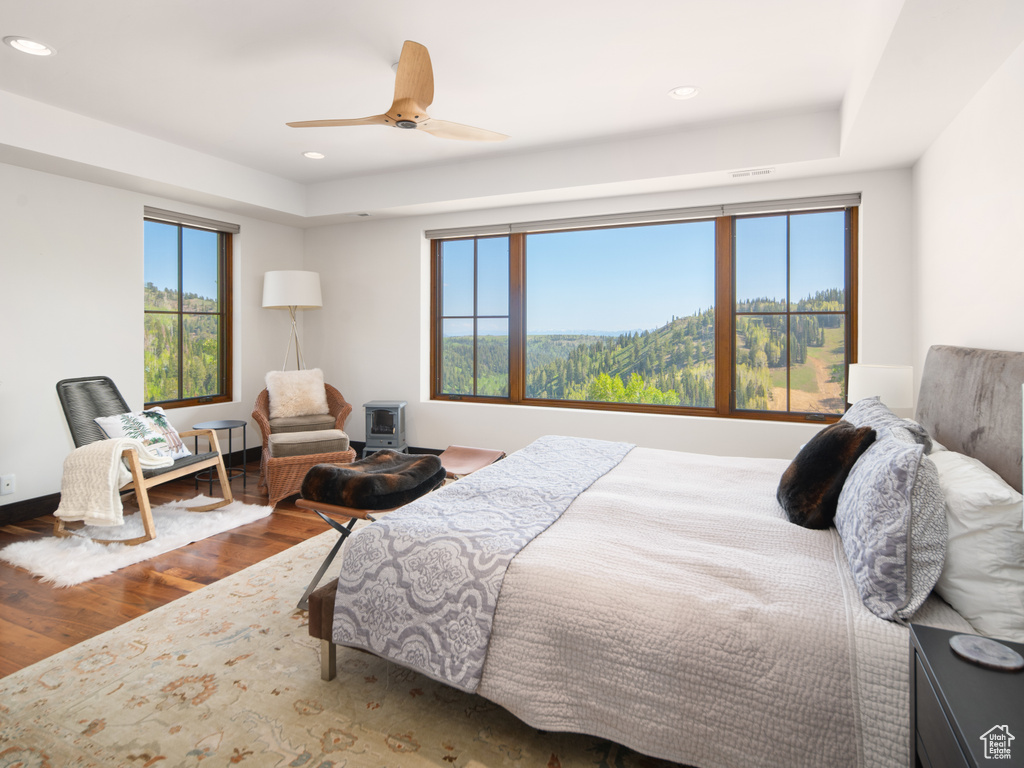Bedroom with wood finished floors, recessed lighting, and a ceiling fan
