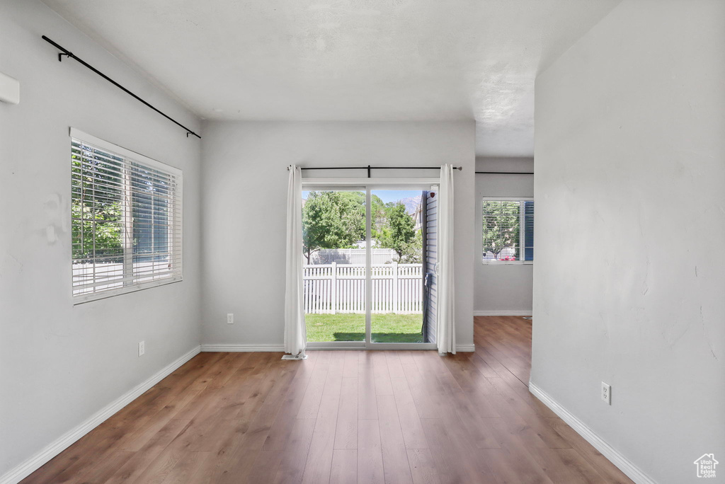 Unfurnished room featuring wood finished floors and baseboards