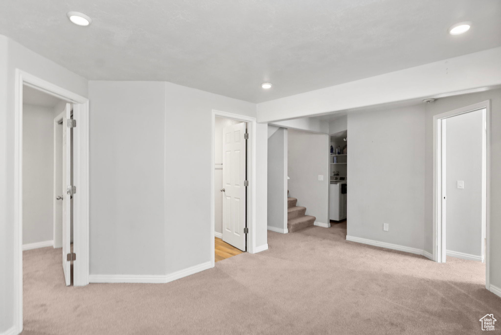 Basement featuring carpet floors, recessed lighting, baseboards, and stairs