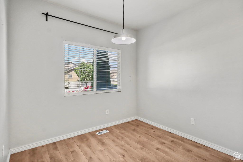 Empty room featuring light wood-type flooring and baseboards