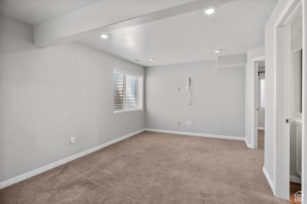 Carpeted spare room featuring recessed lighting and baseboards