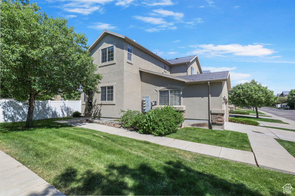 View of side of home featuring stucco siding