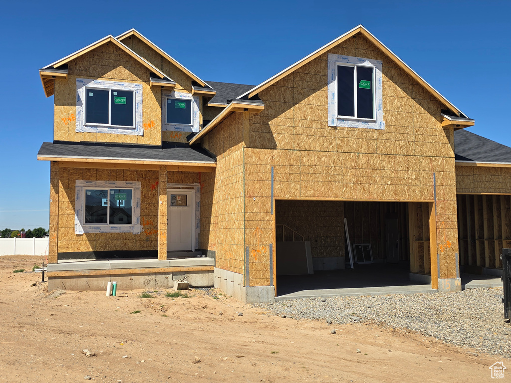 Property in mid-construction featuring driveway, a shingled roof, and a garage