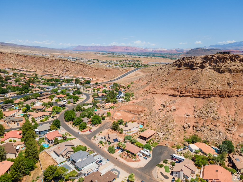 Aerial overview of property's location with a mountain backdrop and a desert landscape