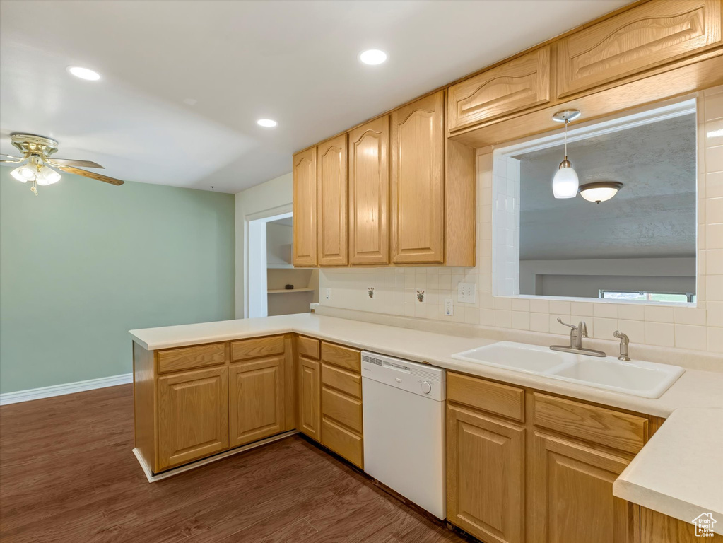 Kitchen with dishwasher, a sink, a peninsula, decorative backsplash, and a ceiling fan
