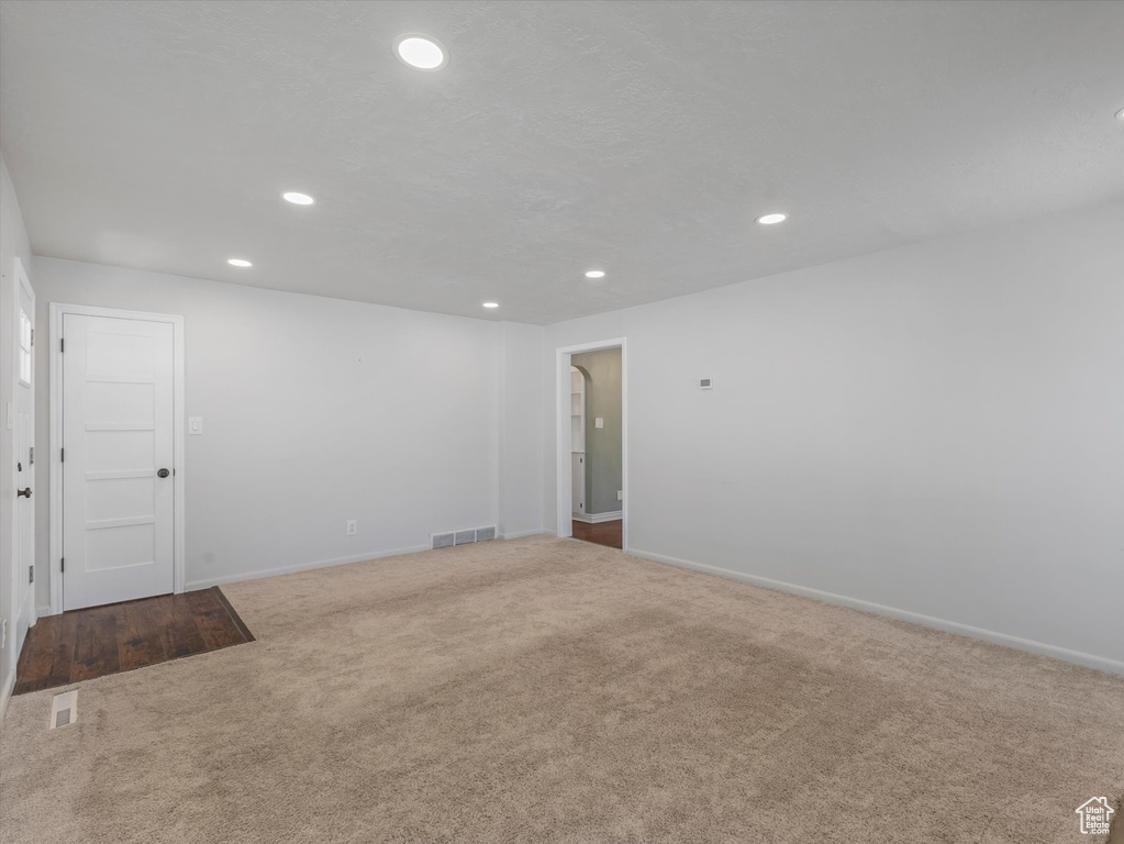 Empty room featuring carpet, recessed lighting, and baseboards