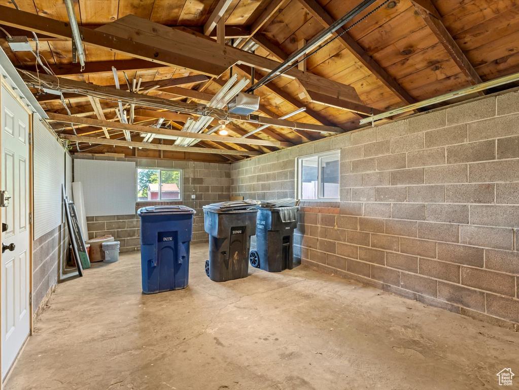 Below grade area featuring concrete block wall and a garage