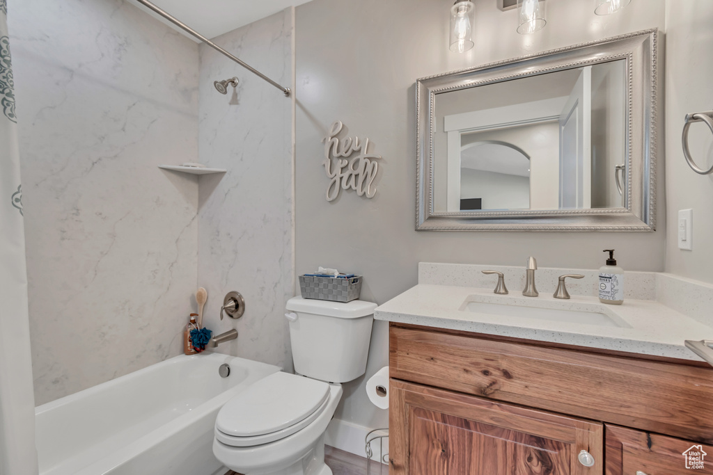 Full bath featuring vanity, bathing tub / shower combination, and toilet