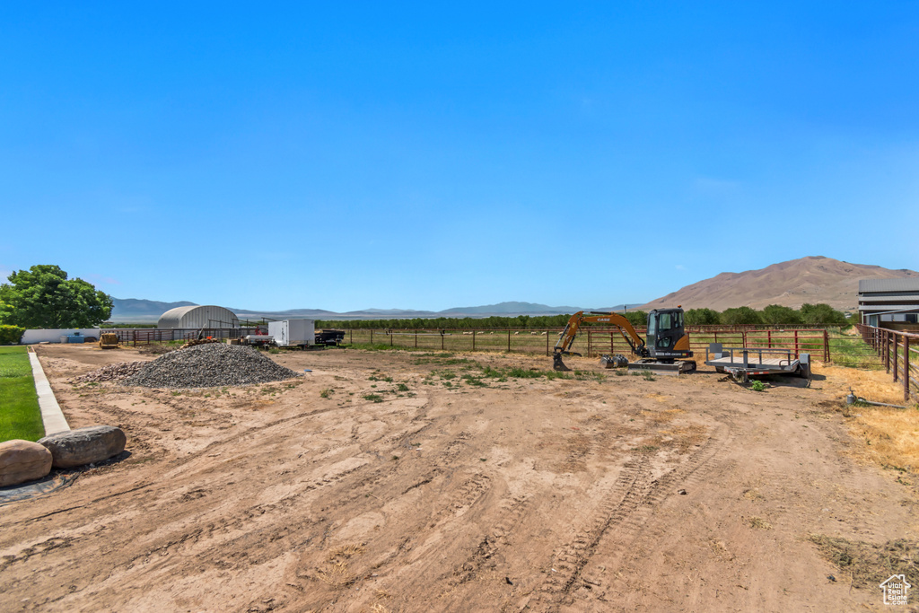 View of yard with a mountain view, a playground, and a view of rural / pastoral area