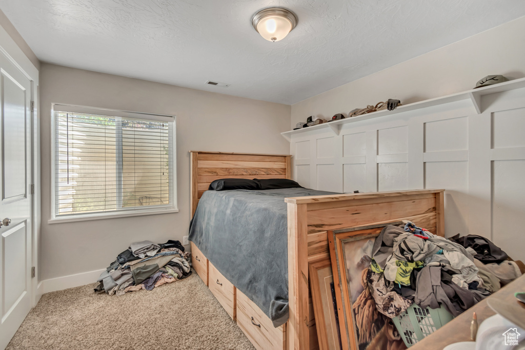 Bedroom featuring carpet flooring and baseboards