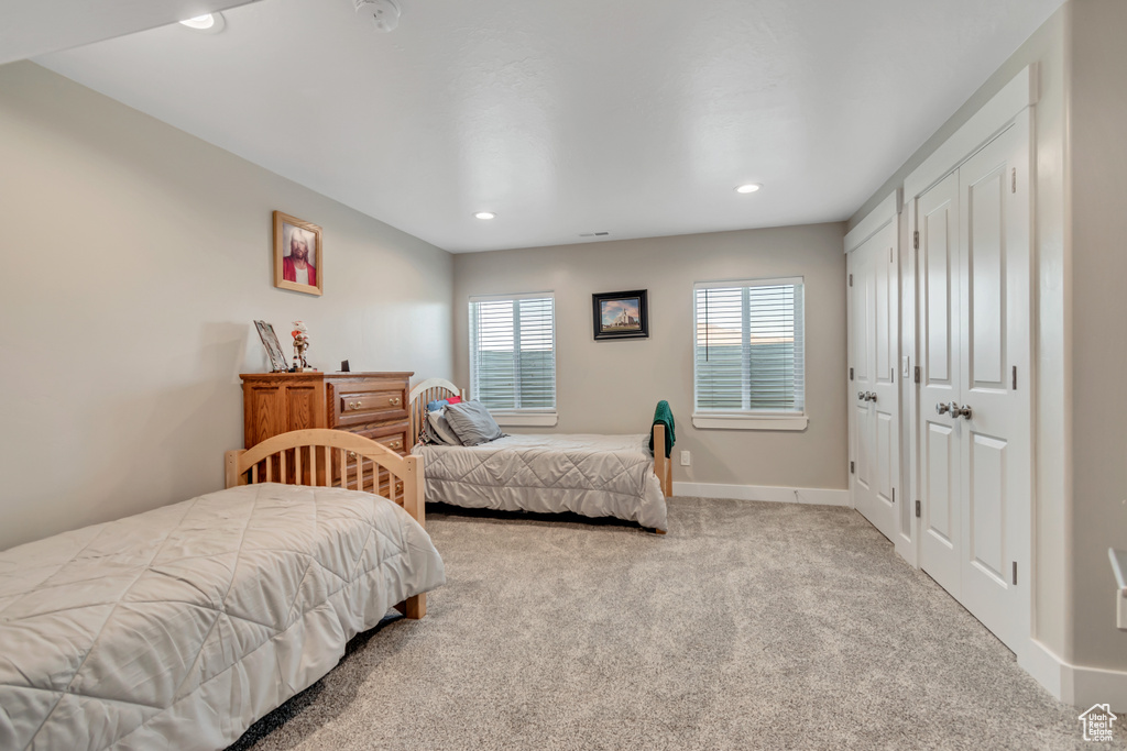 Carpeted bedroom featuring recessed lighting and baseboards