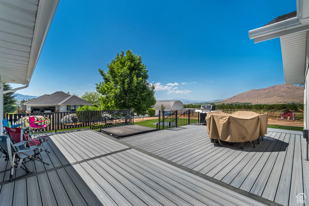 Wooden terrace with a mountain view and a grill