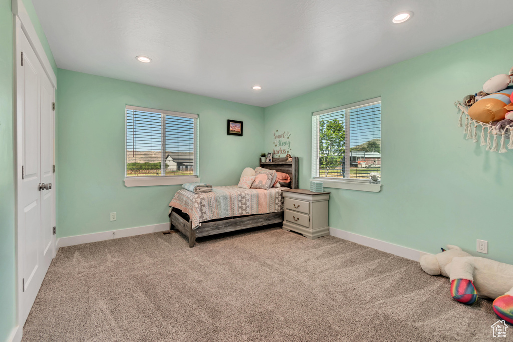 Carpeted bedroom with baseboards and recessed lighting